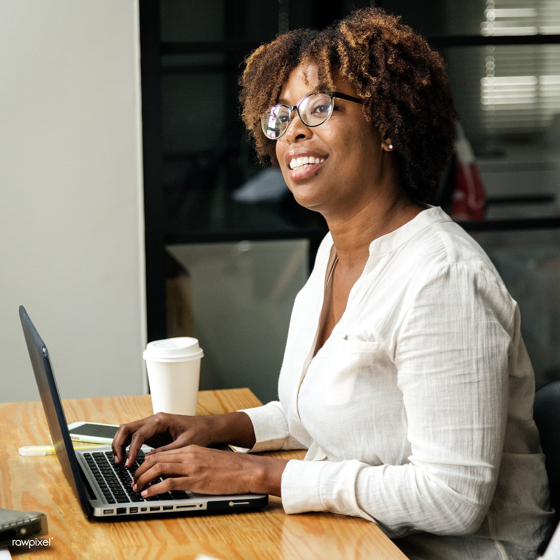 Business owner using a laptop during a website planning meeting