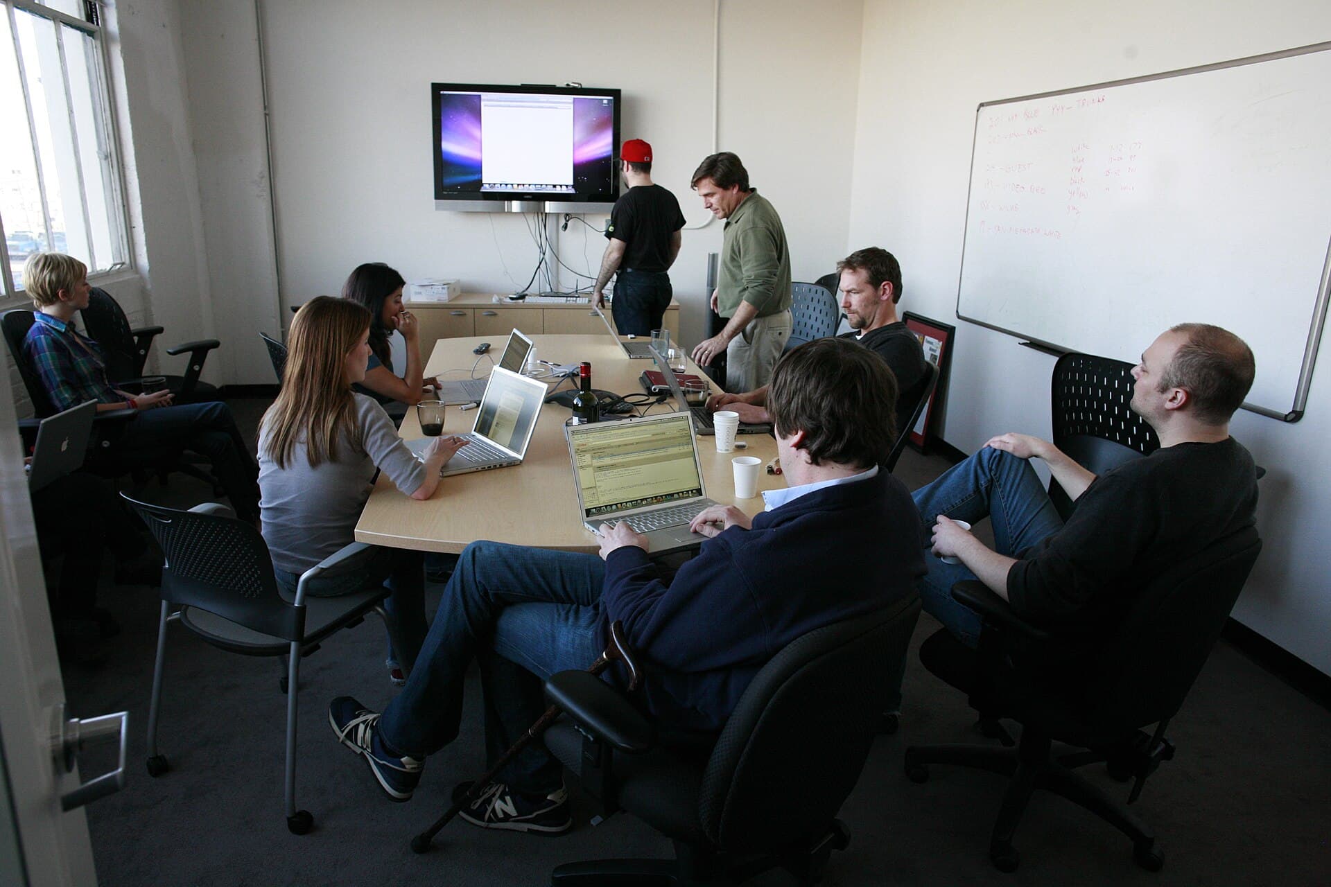 Team discussing business work around a meeting table
